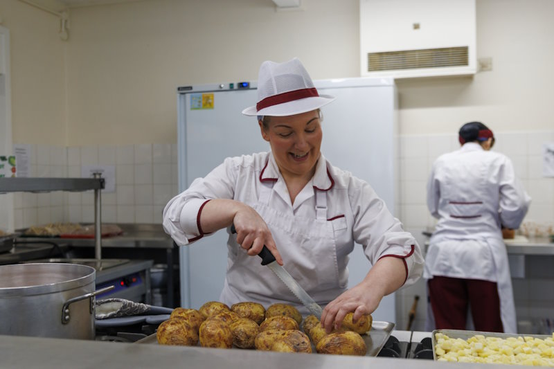 A Citywide chef preparing food in a kitchen