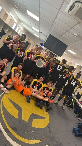 Salford SFA U14 boys team, holding trophy and making hand gestures