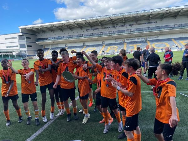 Salford SFA U13 team on the pitch celebrating