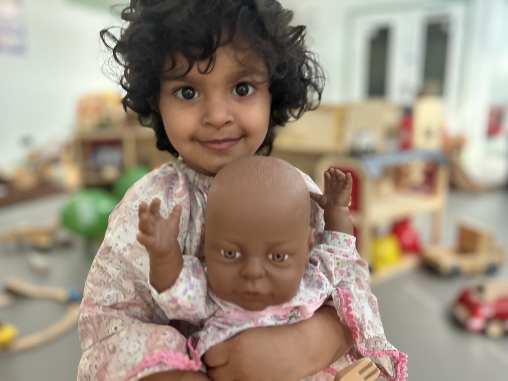 A child playing with a doll at the Alexandra Hub launch