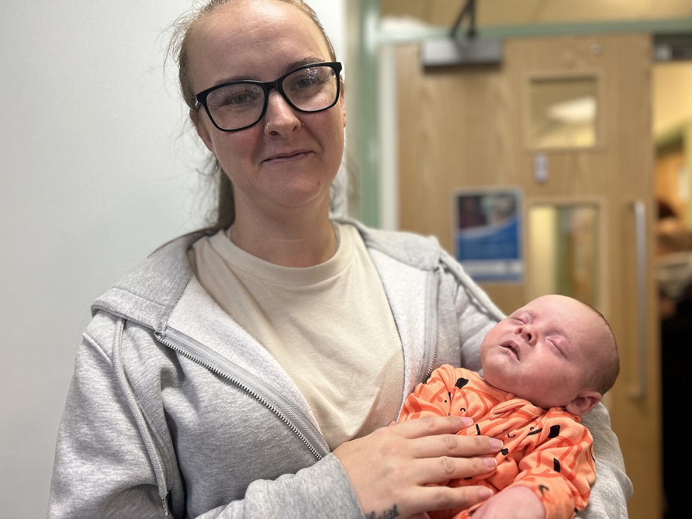 Mum Sarah Cook holding her baby boy Parker Priestley