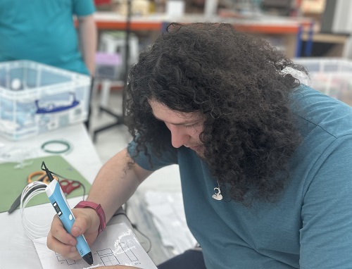 Inclusive bytes team member Paddy Bond with a 3D pen