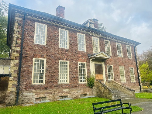 Outside view of Foxdenton Hall in the autumn sunshine 