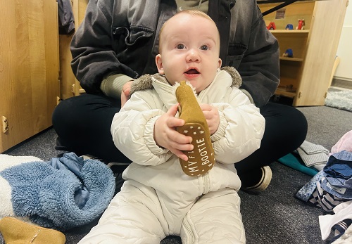 Baby Francesca holding up a shoe 
