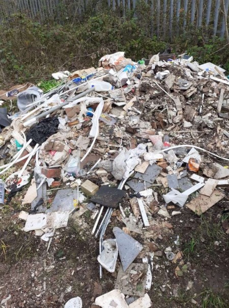 Building boss hit with £1,000 bill after dumping rubbish on open land